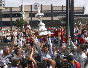03_1504D ©Th.Martinez - Auckland (NZ) . America's Cup 2003. 2nd March 2003.Alinghi Team winner of .America's Cup 2003. Docking ceremony. Ernesto Bertarelli (Alinghi's President and navigator) holding up The Cup and sharing .the victory with Alinghi Team...