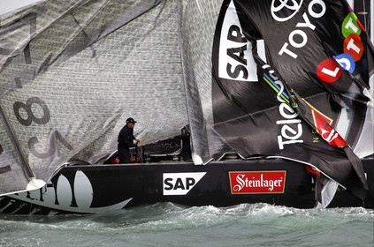 03_0254D ©Th.Martinez - Auckland (NZ) . America's Cup 2003. 28th February 2003. Day 4 .Alinghi (SUI 64) vs Team NZ (NZL 82) .Team NZ's boat dismast 57 minutes after the start in only 18 knots of windwith a swell of 1.5 m. Dean Barker still at the helm, with main sail and mast on deck. Alinghi is leading Team NZ  4-0 after 4 races.