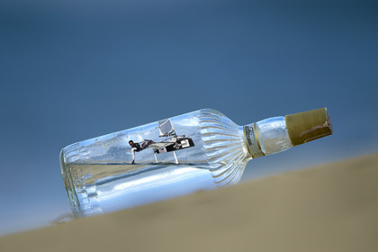 Photomontage.  Bora Gulari (USA) flying Moth in a bottle.