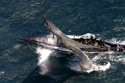 03_0182D ©Th.Martinez - Auckland (NZ) . America's Cup 2003. 15th February 2003. Day 1..Alinghi (SUI 64) vs Team NZ (NZL 82) . .NZL 82 head sails blowing up. Team NZ crew will set up an other head sails and retire after the second one blow up too.. Alinghi 1- Team NZ 0..