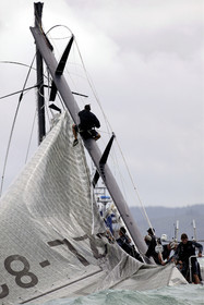 03_0258D ©Th.Martinez - Auckland (NZ) . America's Cup  2003. 28th February 2003. Day 4 .Alinghi (SUI 64) vs Team NZ (NZL 82) .Team NZ's boat dismast 57 minutes after the start in only 18 knots of windwith a swell of 1.5 m. Team NZ crew trying to take off the mainsail  on the broken mast. Alinghi is leading Team NZ  4-0 after 4 races.