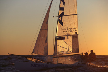 03_3247D© Th.Martinez,STOCKHOLM ARCHIPELAGO SWEDEN, 10 07 03-Archipelago Raid (2003)  Day 3..Team NOKIA-Kempff  Magnus Nordstrom (SWE)& Joakim Kempff (SWE) sailing in sunset light on the way back from Finland to Sweden.