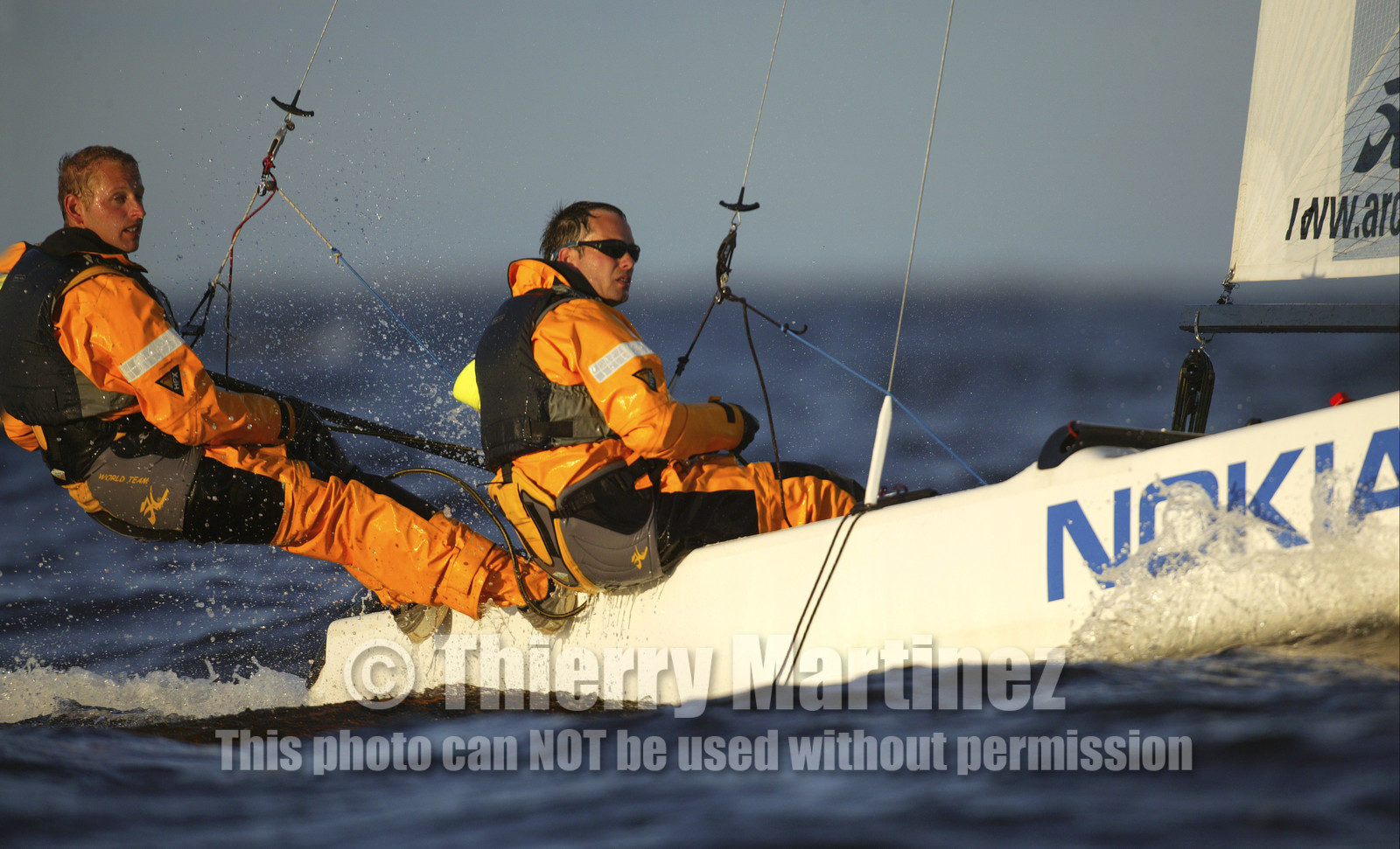 03_3214D 03_3210D © Th.Martinez,STOCKHOLM - SWEDEN10 07 03-Archipelago Raid (2003). Leg4: Marieham (Finland) TO Fejan (SWE). Team Nokia - Kempff , Magnus Nordstrom looking at the map and Joakim Kempff at the helm.