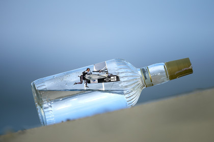 Photomontage.  Bora Gulari (USA) flying Moth in a bottle.