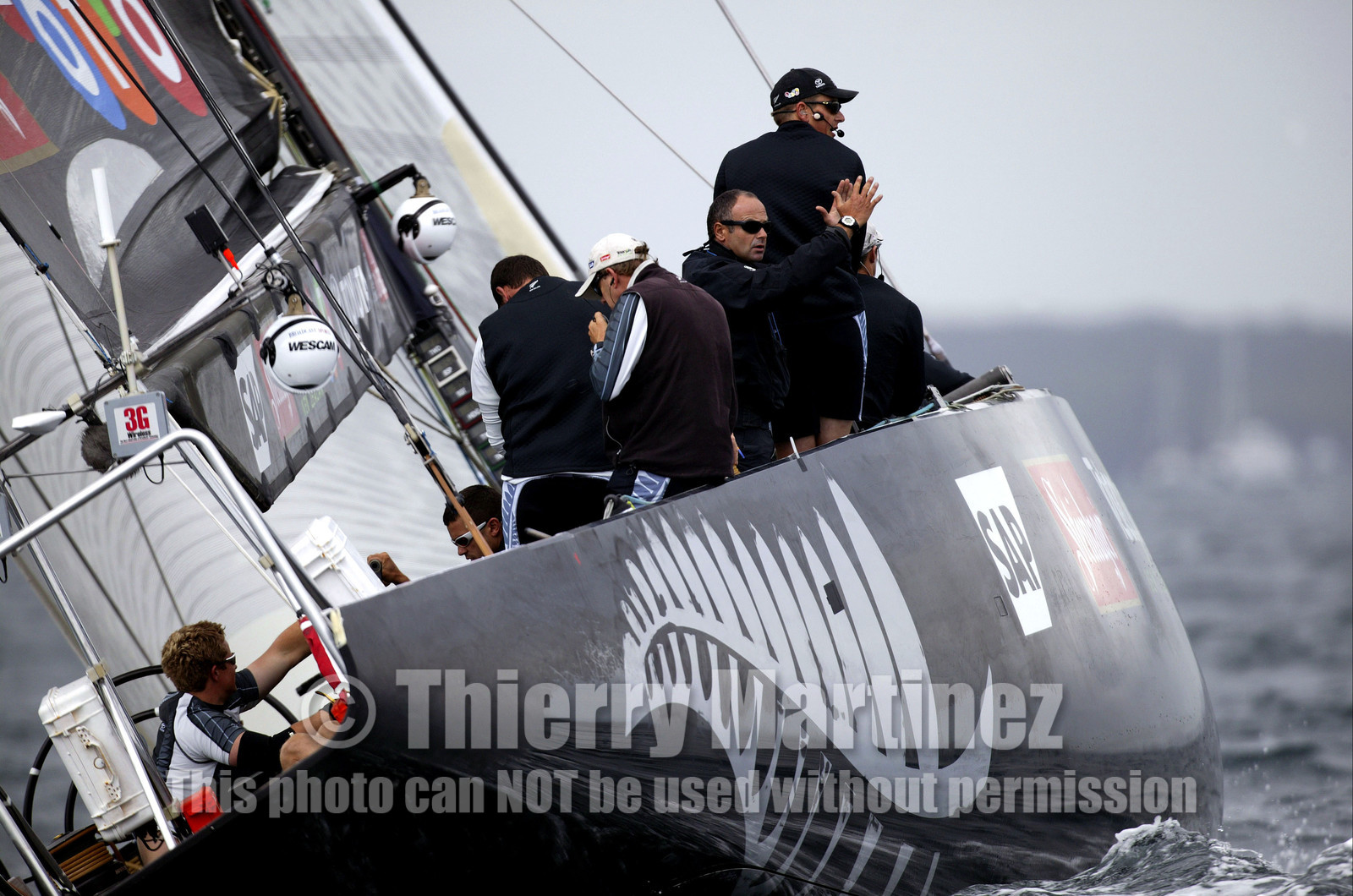 03_0242D ©Th.Martinez - Auckland (NZ) . America's Cup 2003. 20th February 2003. Day 4 Cancelled..Alinghi (SUI 64) vs Team NZ (NZL 82) .Team NZ's skipper Dean Barker at the helm of NZL 82, with frenchman Bertrand Pace (Tactician, on place of Hamish Pepper) for first time on board for America's Cup. Bertrand Pace is the first French sailor to race in n America's Cup match and is the helmsman of NZL 81. The race had been cancelled for wind not enough stable. Race 4 should start on Saturday 22th February...
