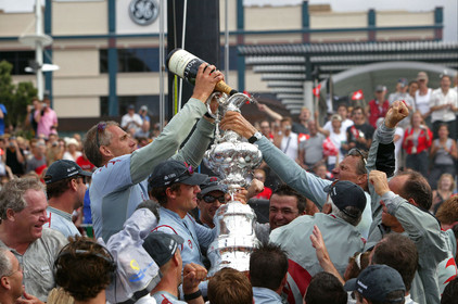 03_1429D © Th.Martinez . Auckland   New Zealand. 2nd March 2003 America's Cup 2003. Day 5, Alinghi (SUI64) vs Team New Zealand (NZL82). .Alinghi winner of the 31st America's Cup (5-0). Docking ceremony, presentation of the America's Cup in the Viaduct Bassin. Grinder Jan Neergaard, .poring MOET champagne in the Cup.