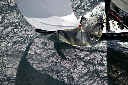 03_0200D ©Th.Martinez - Auckland (NZ) . America's Cup 2003. 18th February 2003. Day 3..Alinghi (SUI 64) vs Team NZ (NZL 82) .Team NZ's crew droping head sail in 2nd Downwind leg...