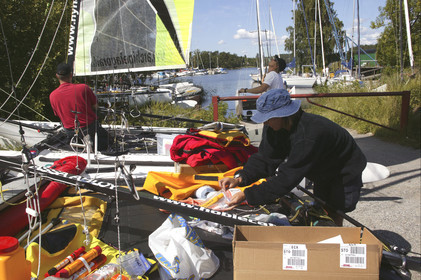 03_3146D © Th.Martinez,STOCKHOLM SWEDEN, 7 07 03-Archipelago Raid (2003) Day 1. Lisa McDonald (USA) preparing safety gear for the Raid.