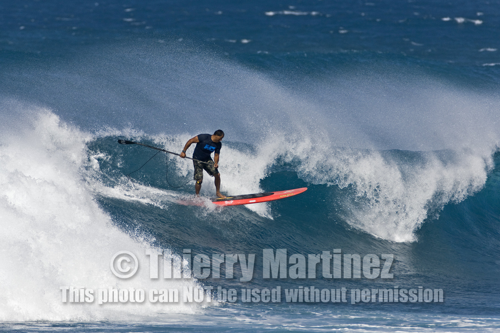 Stand Up Paddle  in waves at Hookip'a Beach - North Shore Maui - Hawaii.