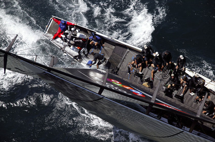 03_0170D ©Th.Martinez - Auckland (NZ) . America's Cup 2003. 15th February 2003. Day 1..Alinghi (SUI 64) vs Team NZ (NZL 82) .NZL 82 in first minutes of Race 1 before retiring on damage. Alinghi 1- Team NZ 0 .Matt Mitchell (Team NZ midbowman) bailing water out of NZL 82. .