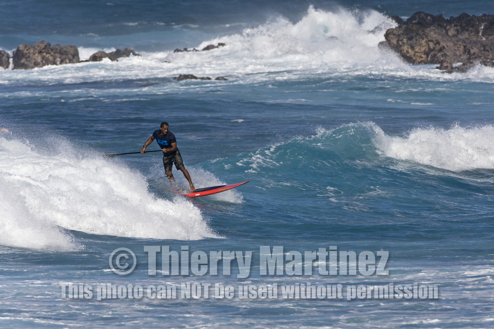 Stand Up Paddle  in waves at Hookip'a Beach - North Shore Maui - Hawaii.
