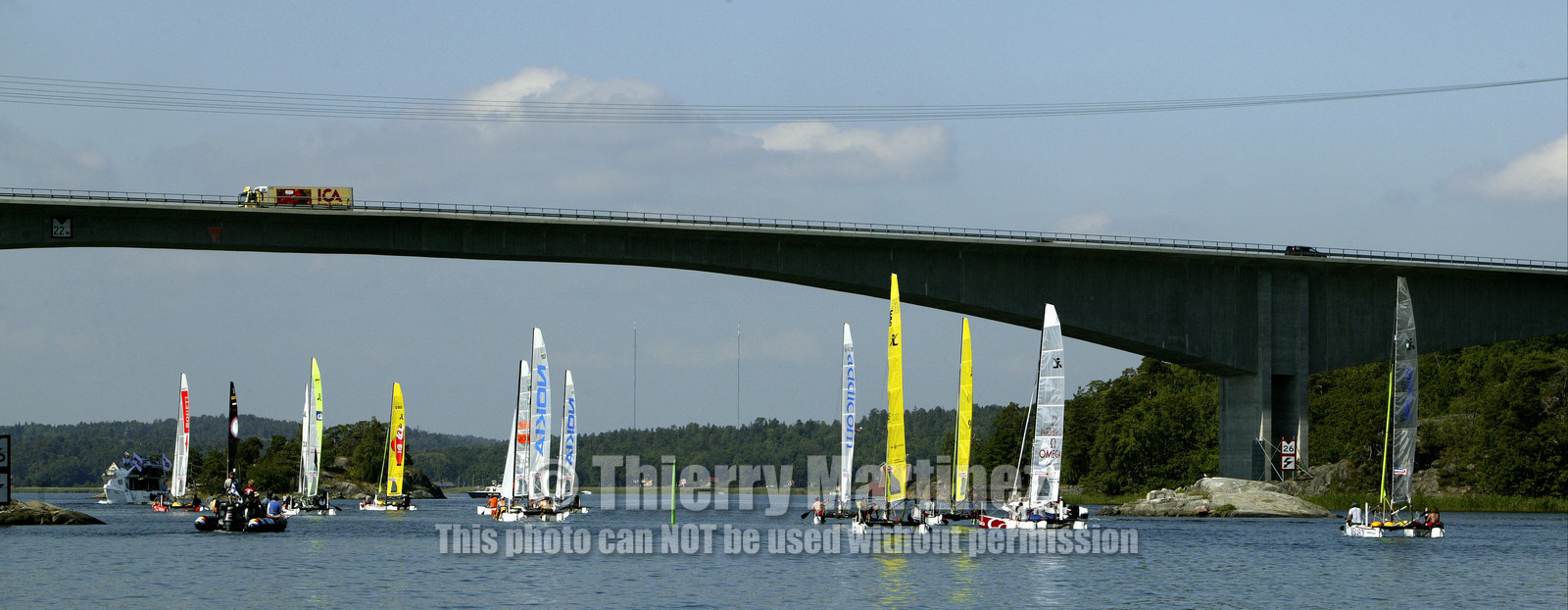 03_3032D © Th.Martinez,STOCKHOLM ARCHIPELAGO - SWEDEN8 07 03-Archipelago Raid (2003)  Day 1..Catamaran fleet under Gustavsberg bridge after the start.