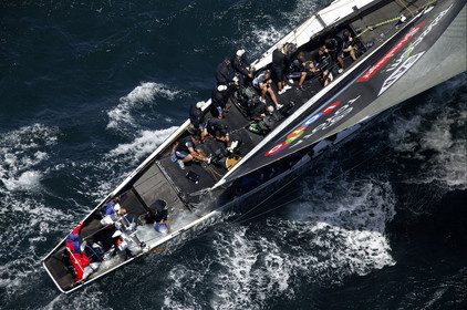 03_0165D ©Th.Martinez - Auckland (NZ) . America's Cup 2003. 15th February 2003. Day 1..Alinghi (SUI 64) vs Team NZ (NZL 82) .NZL 82 in first minutes of Race 1 before retiring on damage..Matt Miichell (Team NZ midbowman) bailing water out of NZL 82. .