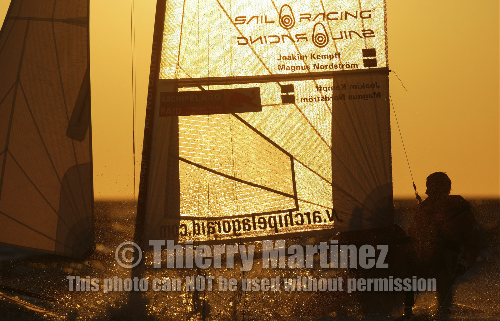 03_3236D 03_3215D  © Th.Martinez,STOCKHOLM - SWEDEN10 07 03-Archipelago Raid (2003). Leg4: Marieham (Finland) TO Fejan (SWE). Team Nokia - Kempff , Magnus Nordstrom and Joakim Kempff at the helm in scandinavian sunset.