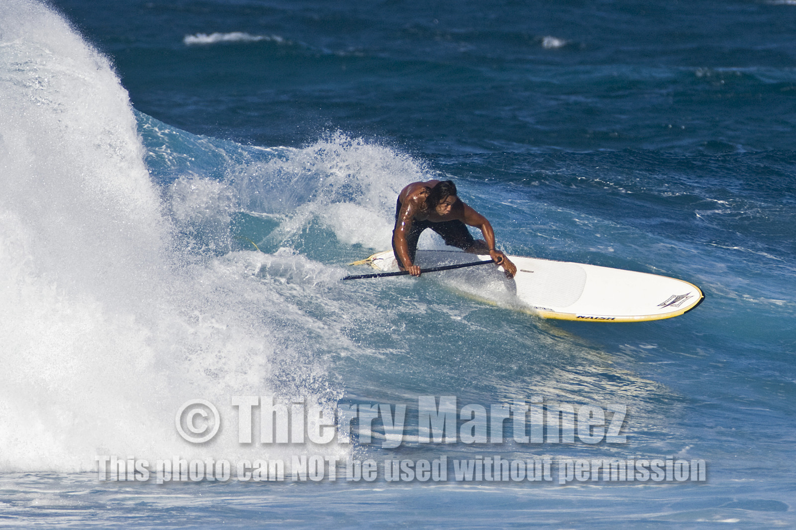 Stand Up Paddle  in waves at Hookip'a Beach - North Shore Maui - Hawaii.