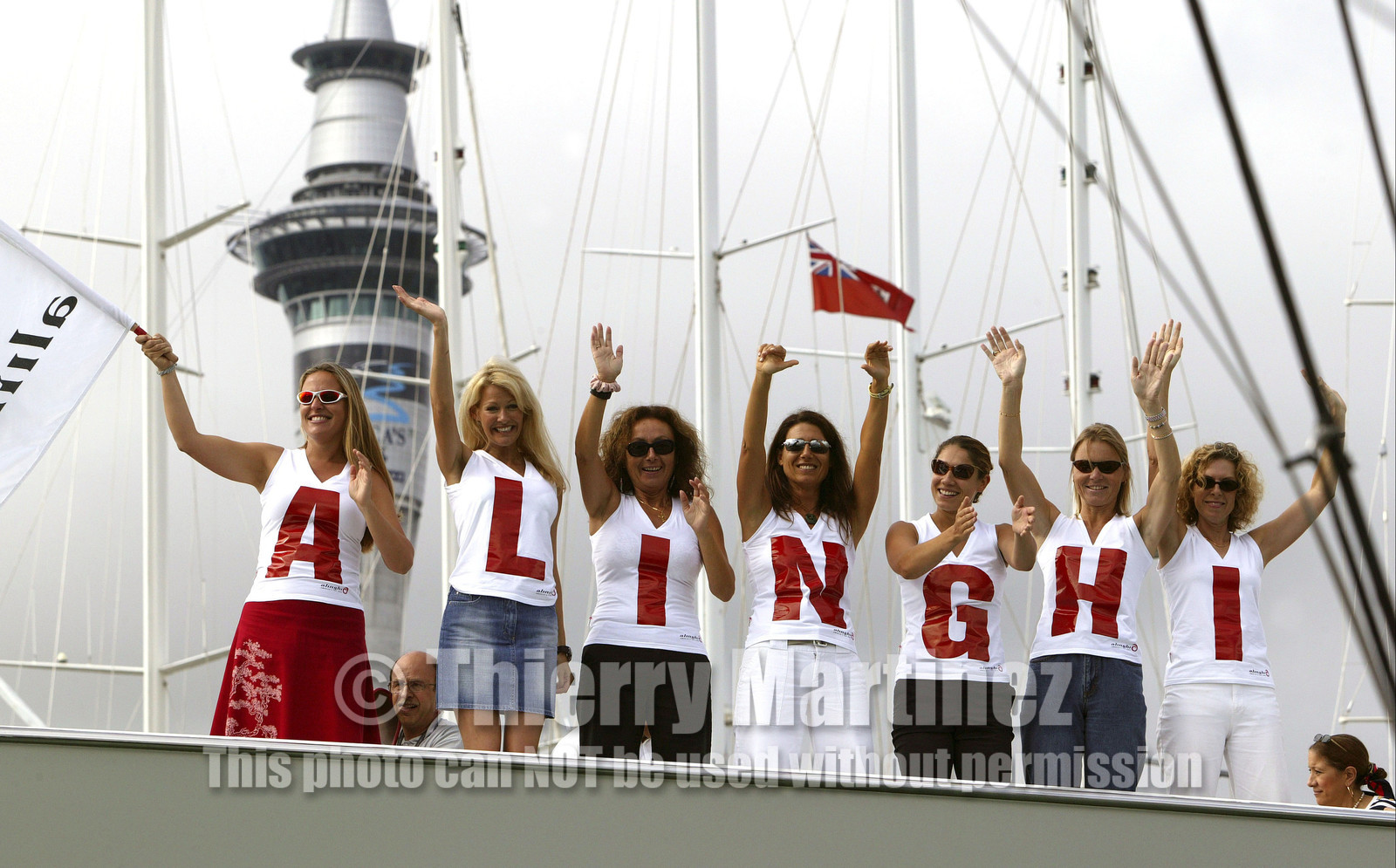 03_1161D © Th.Martinez . Auckland   New Zealand. 1st March 2003 America's Cup 2003.  Day 5 had been cancelled, to enough wind. Alinghi (SUI64) vs Team New Zealand (NZL82). .Alinghi's fans supporting SUI 64 crew on the way out of Viaduc bassin.