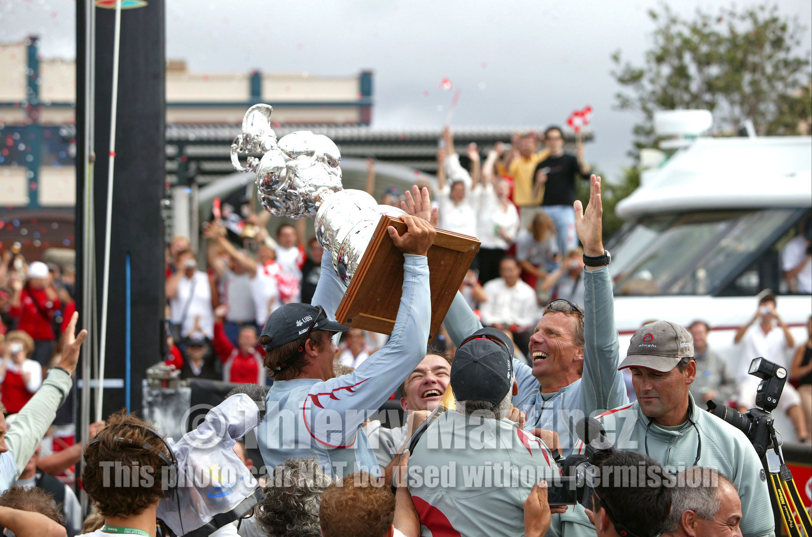 03_1421D © Th.Martinez . Auckland   New Zealand. 2nd March 2003 America's Cup 2003. Day 5, Alinghi (SUI64) vs Team New Zealand (NZL82). .Alinghi winner of the 31st America's Cup (5-0). Docking ceremony, presentation of the America's Cup in the Viaduct Bassin..Alinghi afterguard, Ernesto Bertarelli, Jochen Schuemmann, Brad Butterworth holding the America”s Cup.