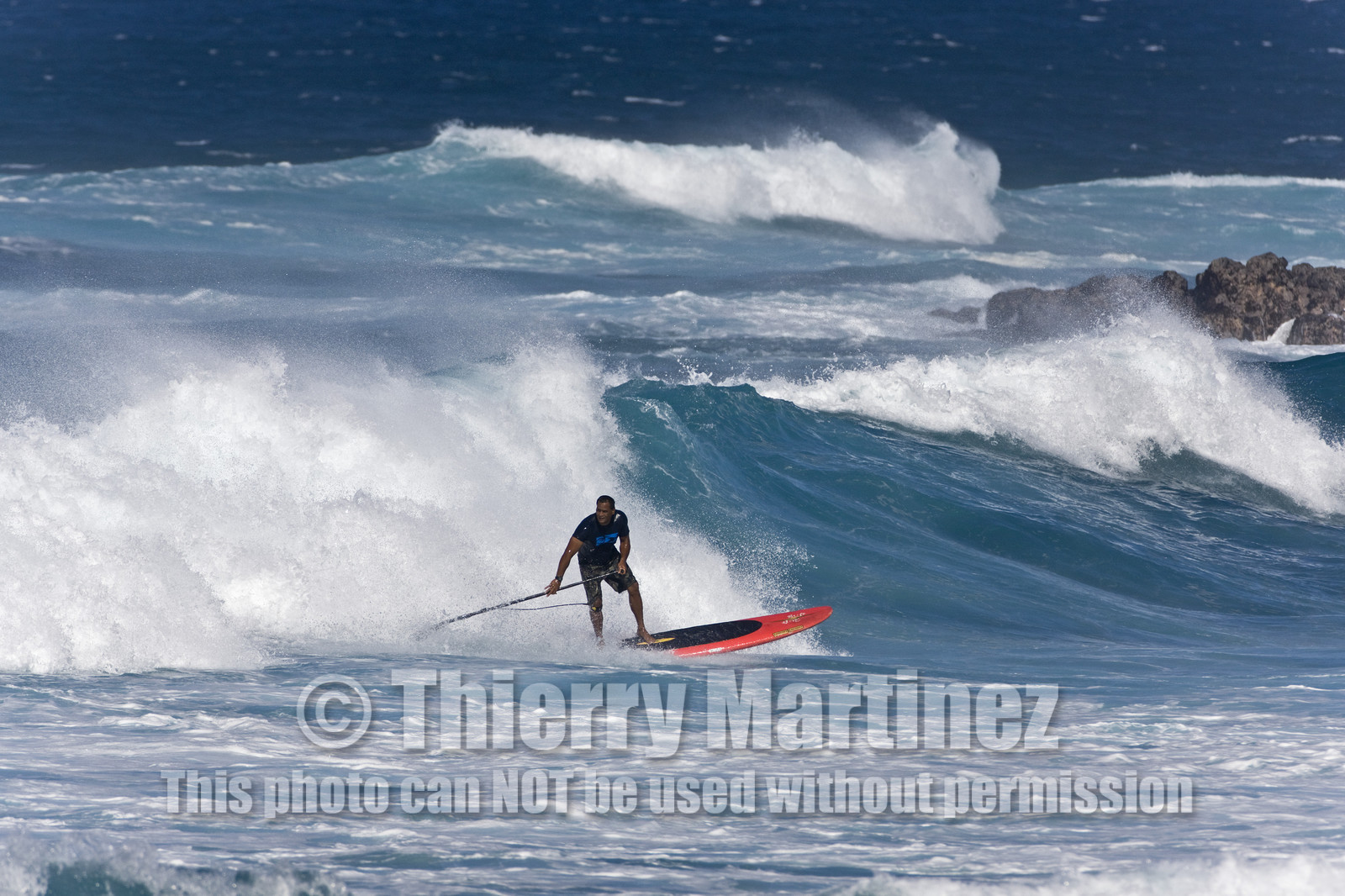 Stand Up Paddle  in waves at Hookip'a Beach - North Shore Maui - Hawaii.