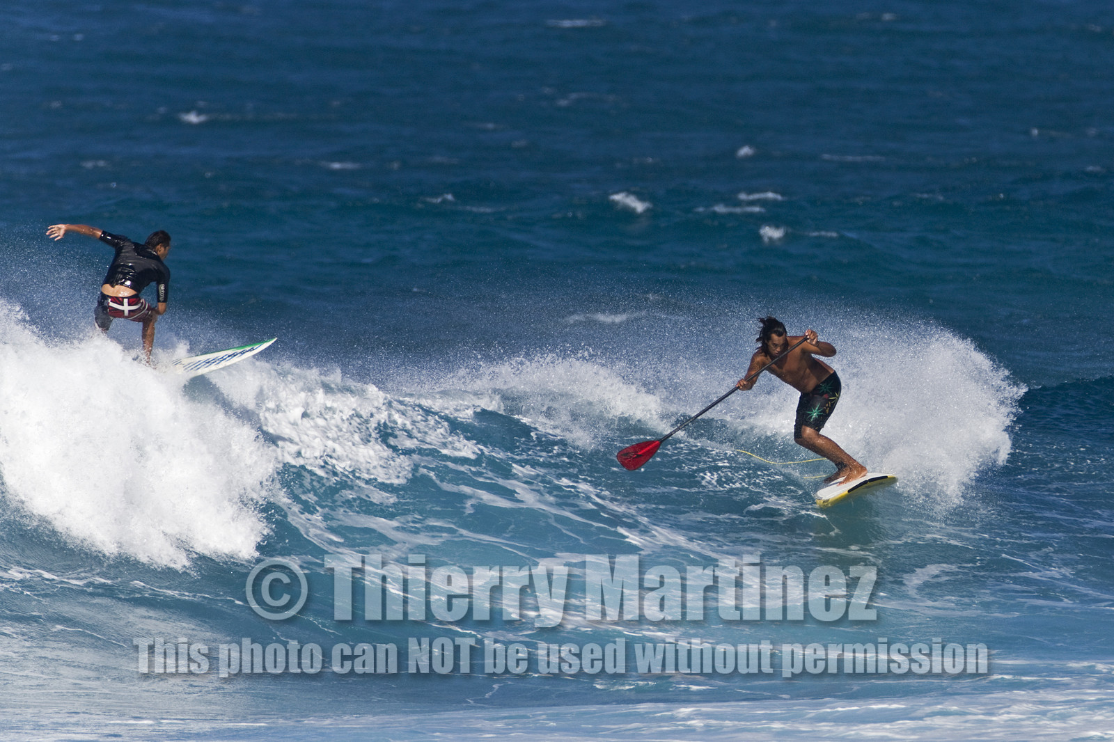 Stand Up Paddle  in waves at Hookip'a Beach - North Shore Maui - Hawaii.